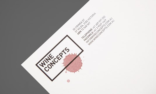 The subtle Wine Concepts logo and contact details are printed in black at the top of a page, with a splash of red wine over part of the logo