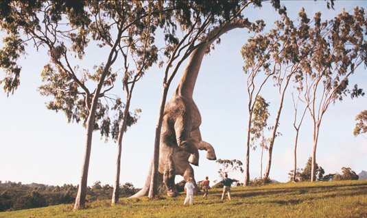 jurassic park still of dinosaur and people staring at it
