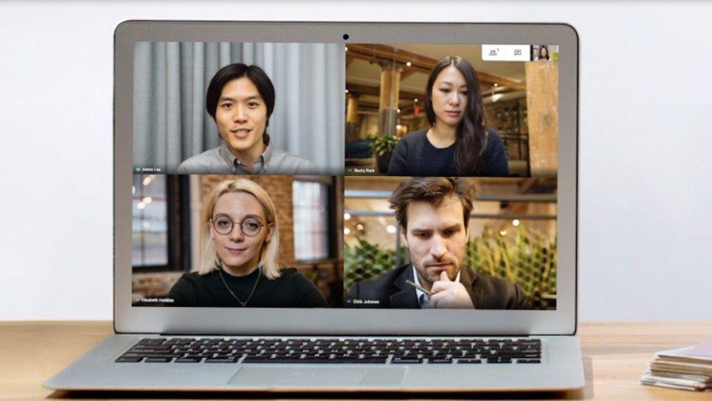 Four people on video call on laptop screen