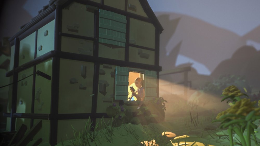 Girl reading on a barn porch at night illuminated by a backlight