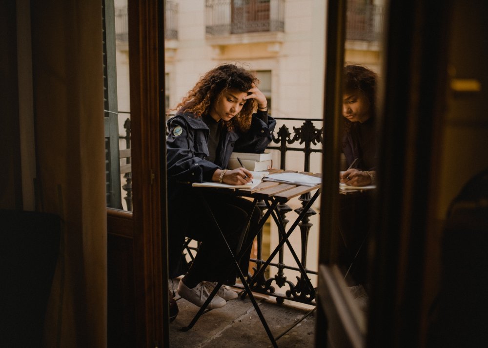 Young woman studying on her balony