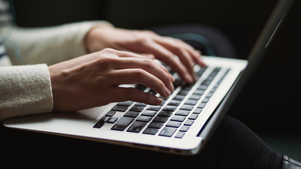 Person typing on keyboard