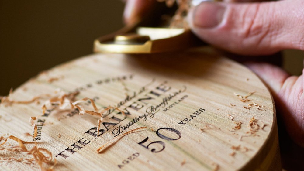 Carpenter carving a wooden box