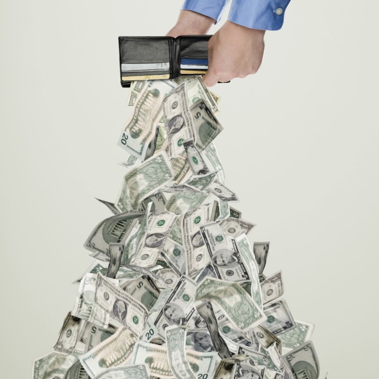 Money pouring out of wallet