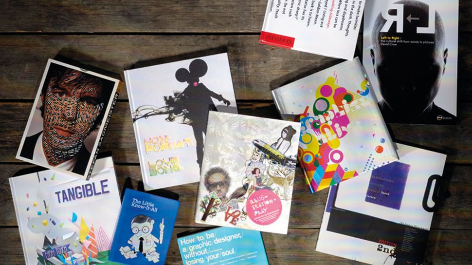 Various books on graphic design laid out on a table