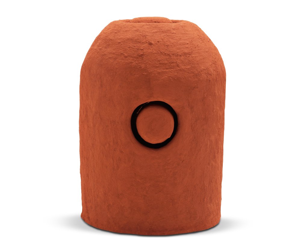 Orange/brown sculpture with rounded top and a circular shape cut into the middle