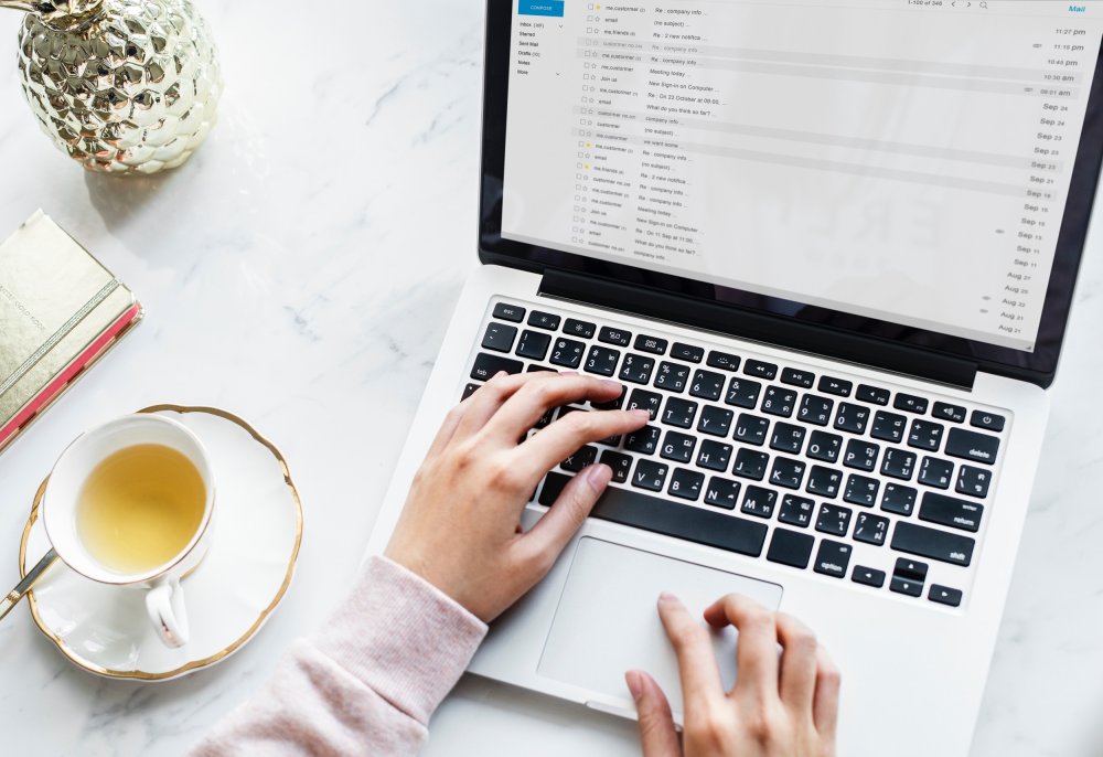 person checking emails on laptop