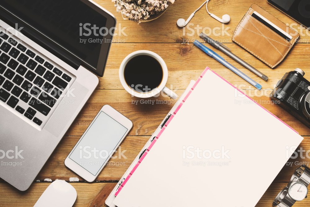 Blank report cover on desk with laptop and phone