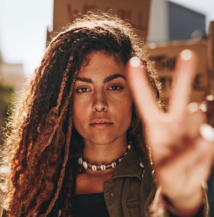 woman making peace sign - Adobe Stock