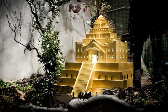 Model temple with miniature figures in a window displat