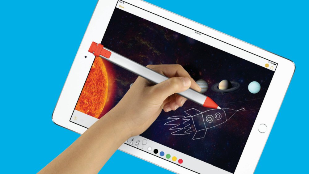 Person using the Crayon to draw a rocketship on a diagram of the universe displayed on an iPad