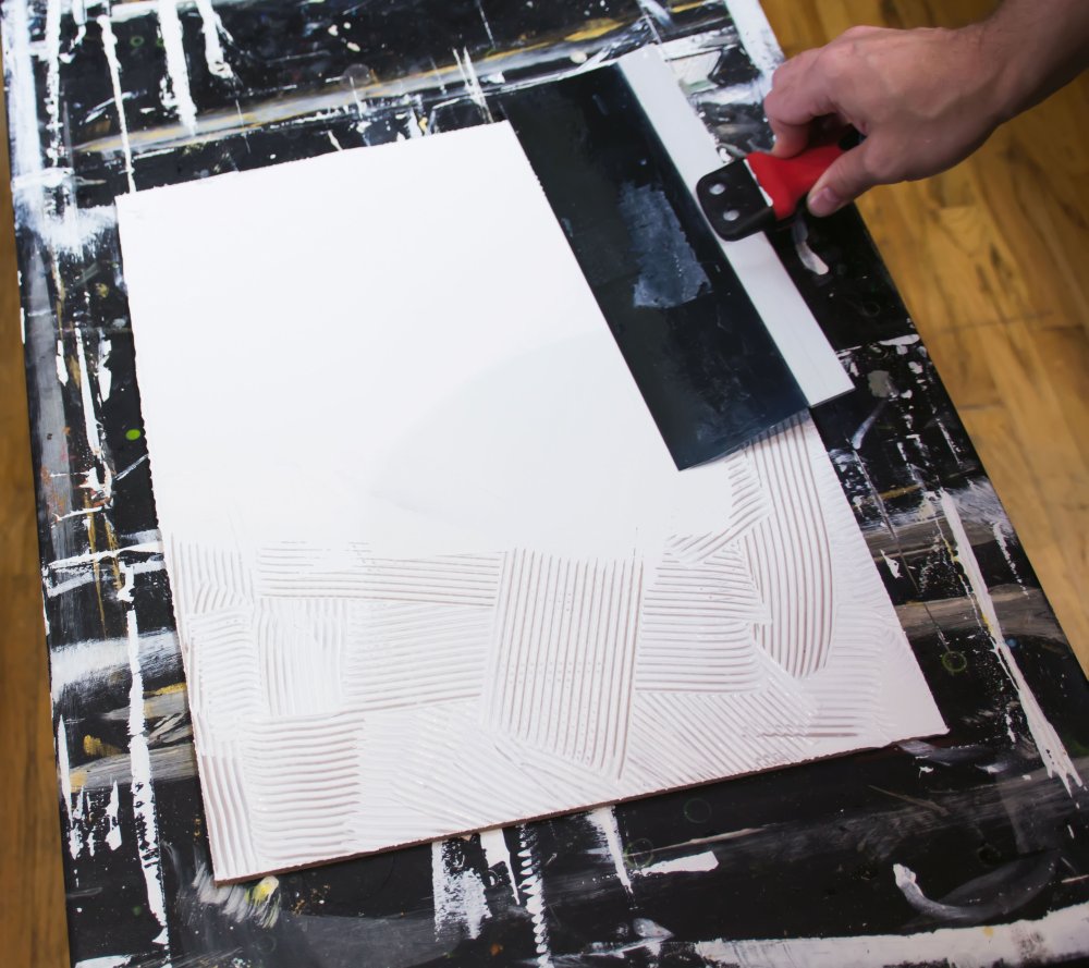 A taping knife smoothing gesso