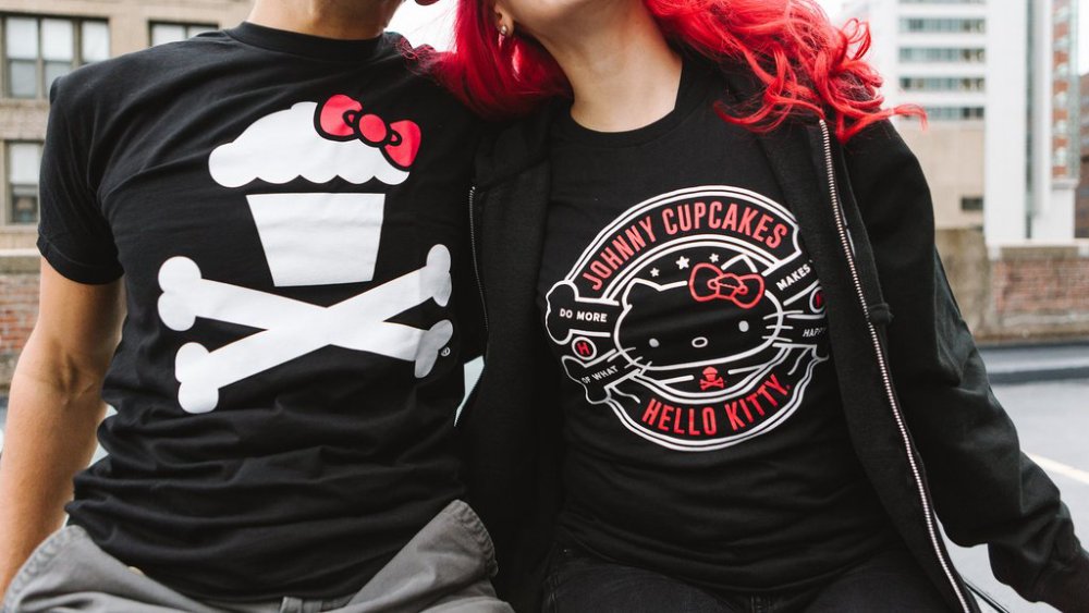 Man and woman wearing Johnny Cupcakes T-shirts with Hello Kitty-themed illustrations