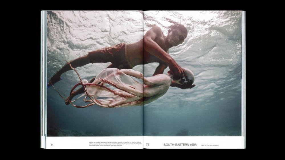 Double page photo of a man catching an octopus underwater, from Migrant Journal