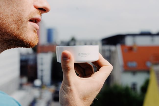 man holding amazon echo