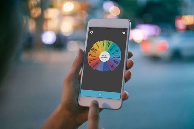 Person holding phone displaying Buddhify app