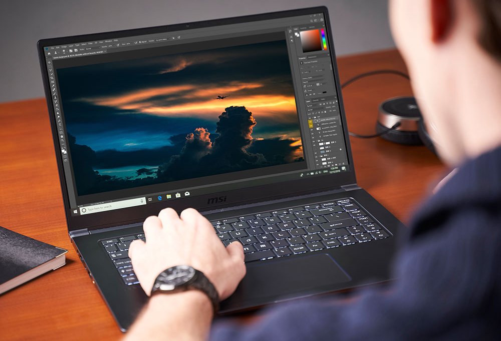 Over-the-shoulder photo of a man using the MSI PS63 Modern