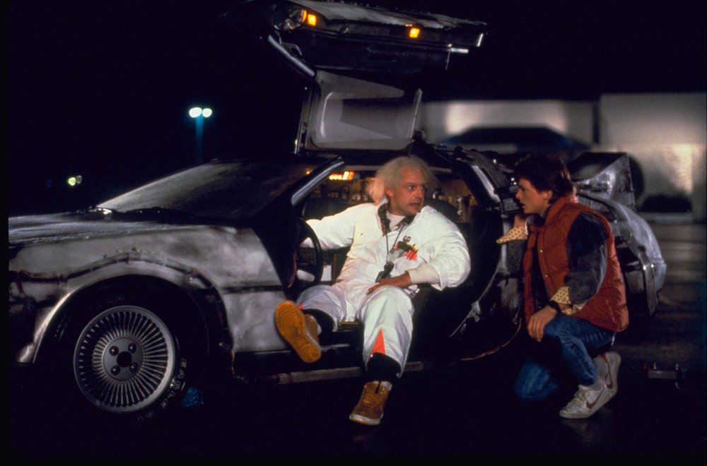 Doc Brown sitting in the Delorean talking to Marty McFly