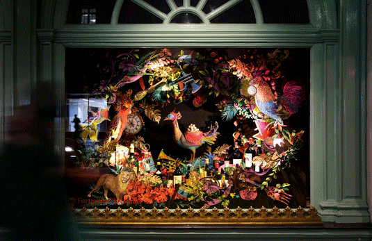 Wild animals made of intricately folded coloured paper fill a window at Fortnum and Mason