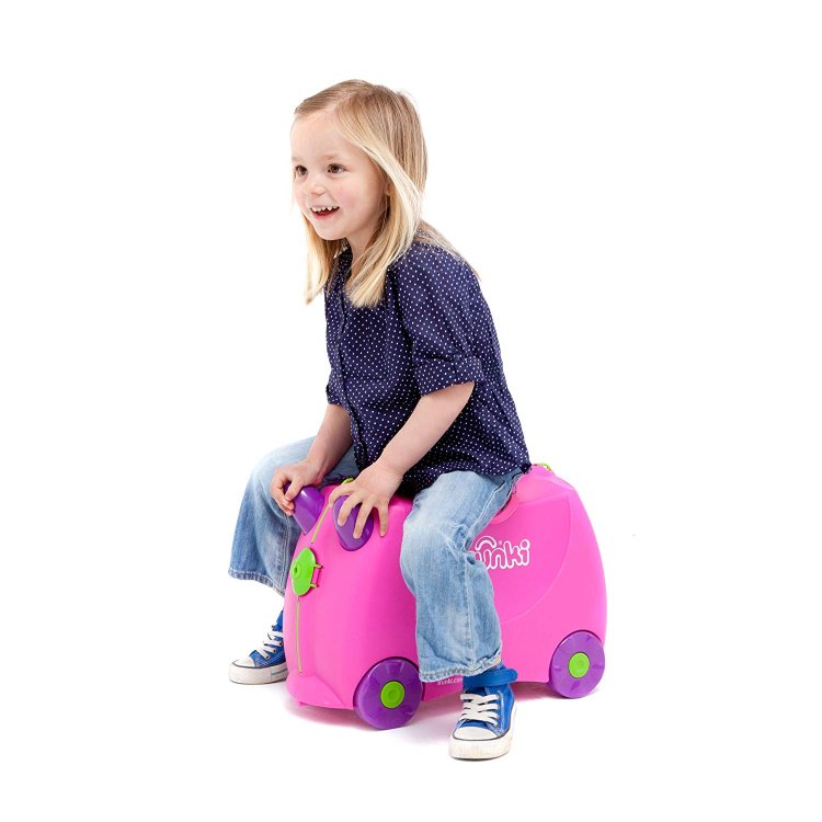Small girl riding a Trunki