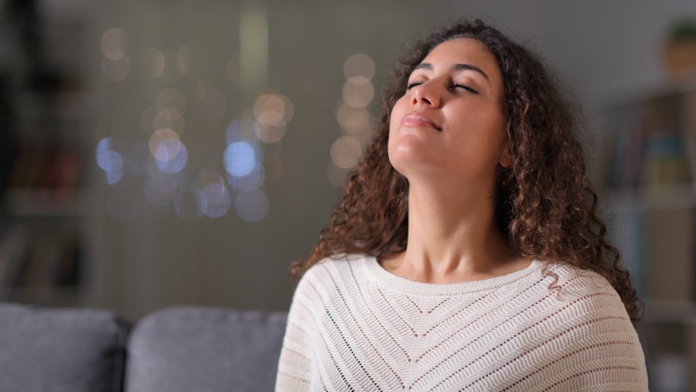 Woman on sofa breathing deeply