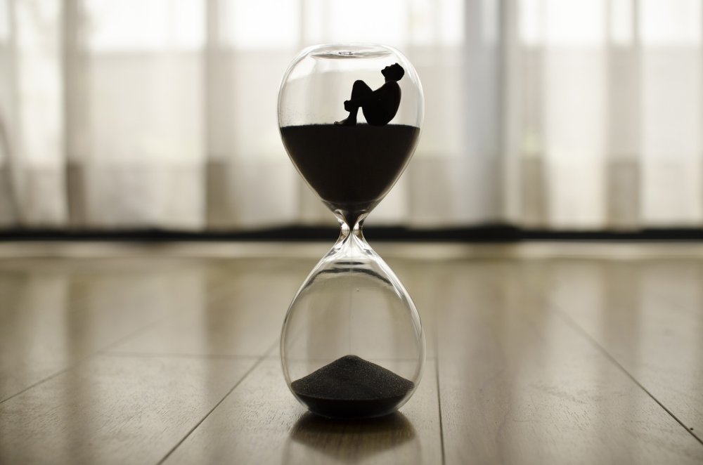Silhouetted figure inside hourglass