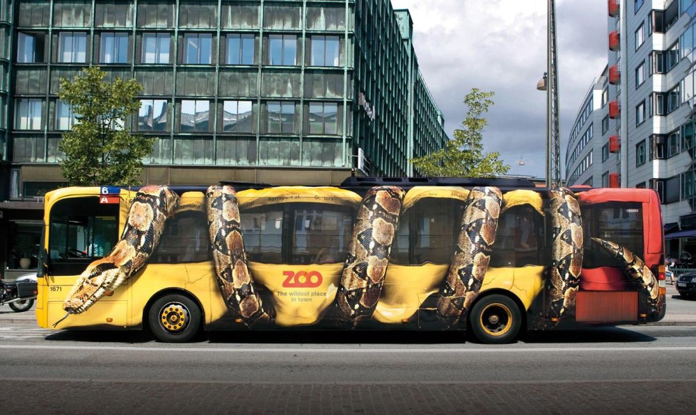 Bus wrap that looks like a snake crushing the vehicle