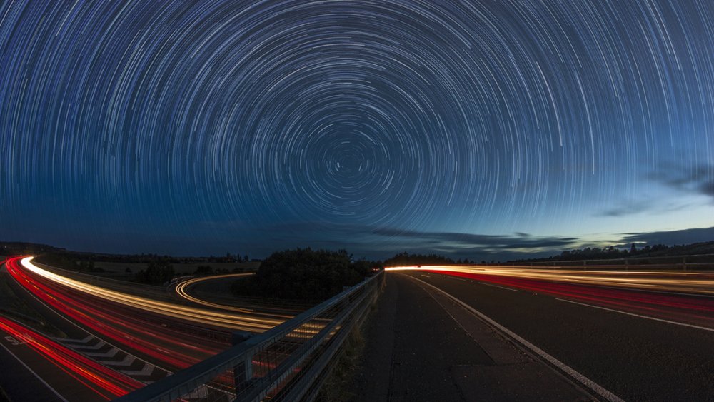 Star trails over a busy road